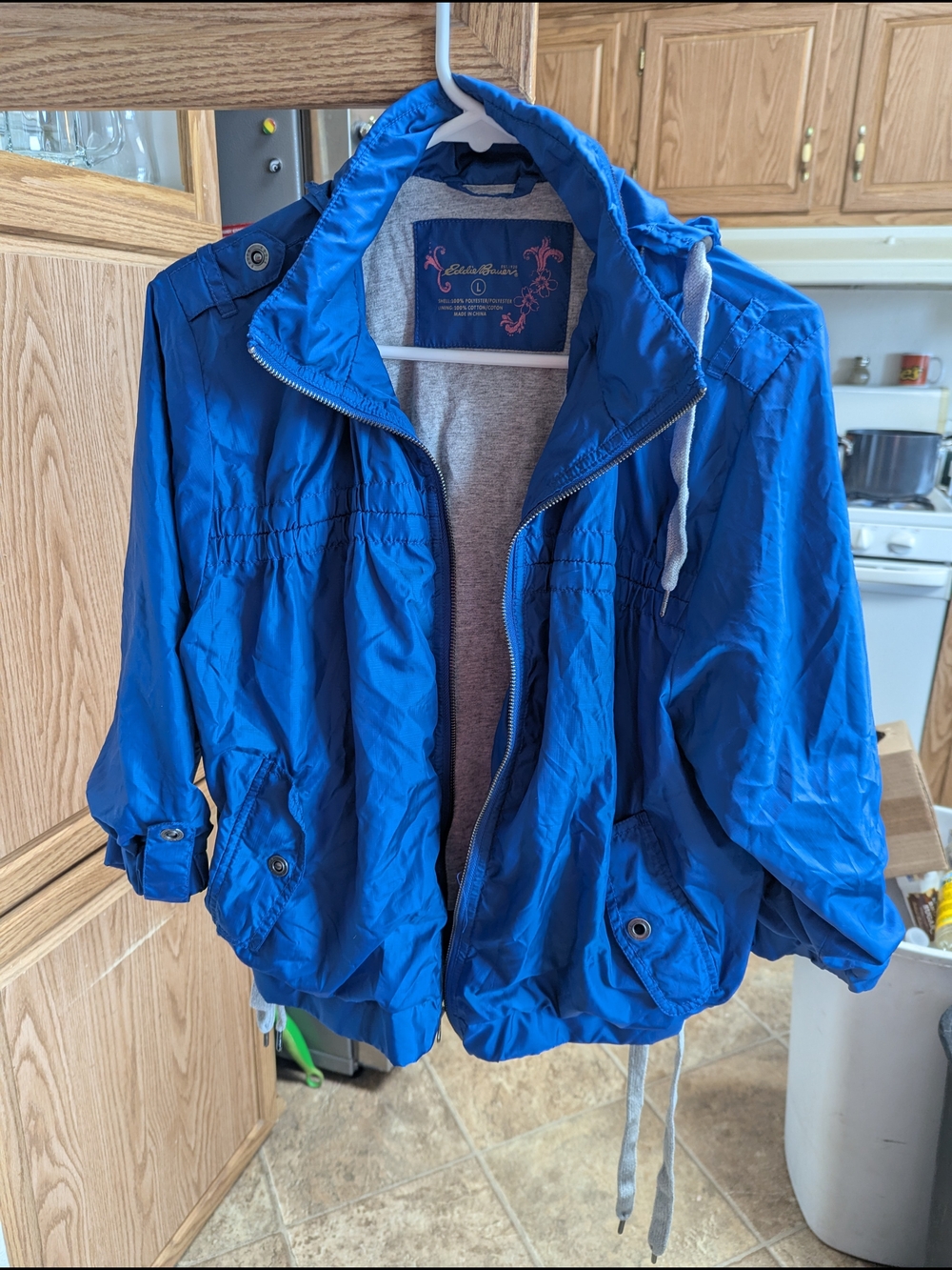 Eddie Bauer blue windbreaker with a packable hood Women's size large